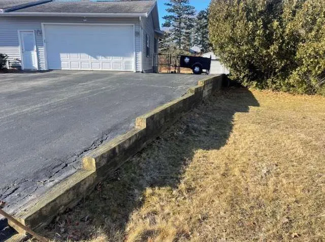 Failing retaining wall beside a driveway before the rebuild