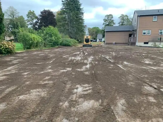 Cleared and graded lot with an excavator