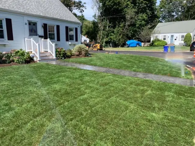 Freshly mowed lawn with a sprinkler running